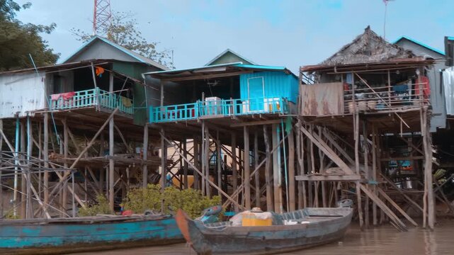 The view of famous fisherman houses on stilts of Kampong Phluk floating village from across the Tahas river. Siem Reap, Cambodia