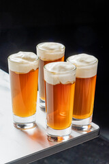 Four filled glasses are arranged, each topped with a generous layer of whipped topping