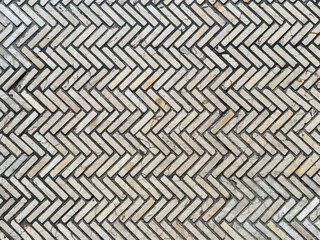 Close up of mosaic tiles in chevron pattern. Chevron subway or light beige mosaic tiles, suitable or flooring, wall, bathroom, toilet, and kitchen. Seamless background texture.