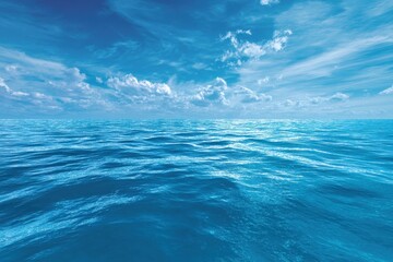 Vast blue water panorama showcasing gentle waves and a clear sky with scattered clouds during a sunny day