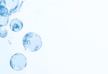 Abstract background with translucent blue bubbles floating on light surface. Clean and minimal design perfect for skincare, hygiene, purity, or scientific themes
