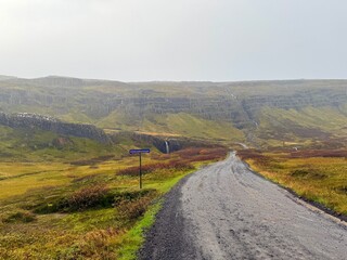 Klifbrekkufossar Waterfall in Mj&oacute;ifj&ouml;r&eth;ur, Eastfjords of Iceland, Multi-Tiered Cascades through Mossy Cliffs