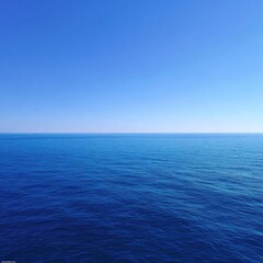 Fototapeta premium Vast expanse of azure ocean meeting a clear, cloudless sky