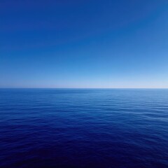 Obraz premium Vast expanse of deep blue sea meeting a clear, cloudless sky