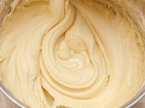 A bowl of batter is being mixed