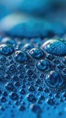 Close-up view of water droplets on a textured blue surface