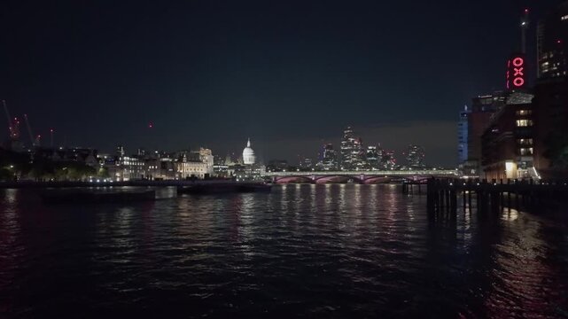 London, UK. September, 27, 2025, Beautiful view of the London skyline at night, with city lights reflecting on the River Thames. Famous landmarks include OXO Tower and St Paul's Cathedral