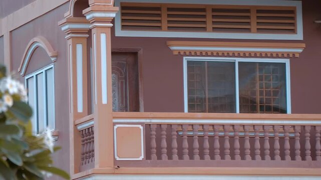 A big balcony with columns and balusters of a modern house built in traditional Khmer style, Siem Reap, Cambodia