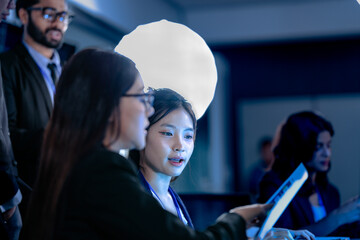 Briefing future AI insights. Lead analyst points out predictive patterns AI generated report chart team discusses strategic implications real time data streams flow screens background.