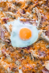 Pizza with egg, ham and melted cheese
