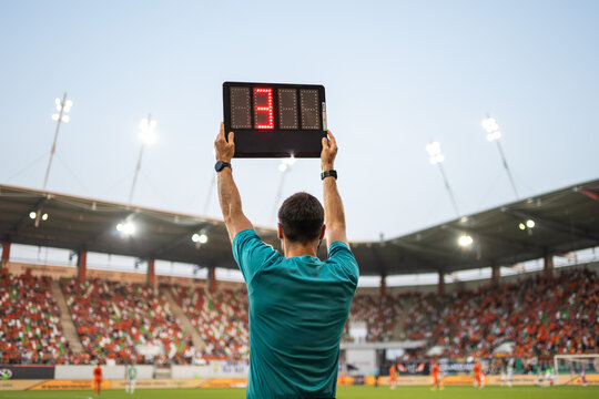 Technical referee shows 1 minute added time during the football match.