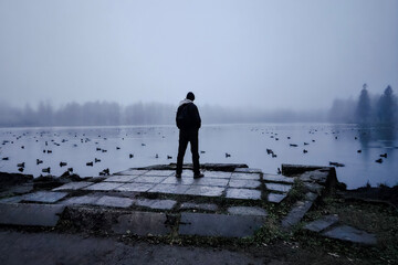 The tall man looks into the distance, gloomy photo