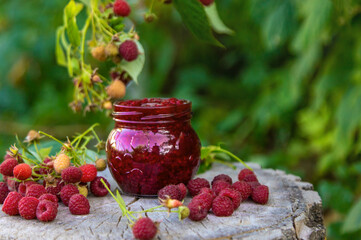 Raspberry jam in the garden. Selective focus.