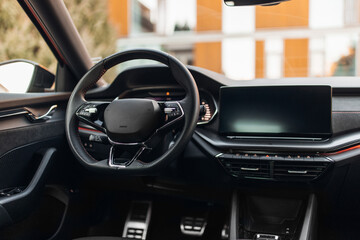 Modern expensive car interior with leather panel, sport seats, multimedia and digital dashboard