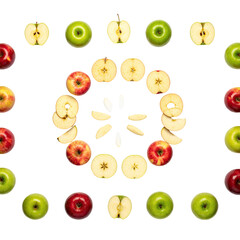 A symmetrical arrangement of apples, whole, sliced, and halved against a black backdrop