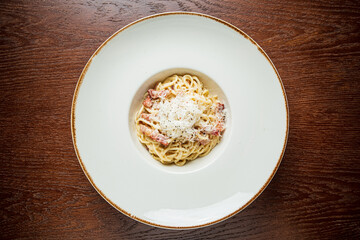 A tempting bowl of creamy pasta with cheese and seasoning, ready to be enjoyed at dinner