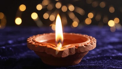 3_Diwali diya oil lamp on a blue and dark background Celebration light of festival_4K_10s 10016346 1 - Powered by Adobe
