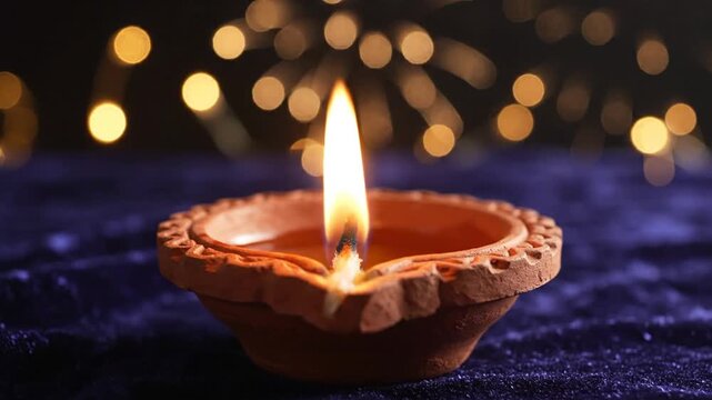 3_Diwali diya oil lamp on a blue and dark background Celebration light of festival_4K_10s 10016346 1