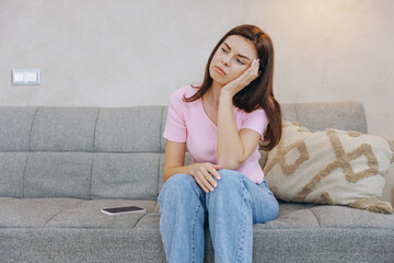 Sad woman feeling unwell and suffering from disease at home