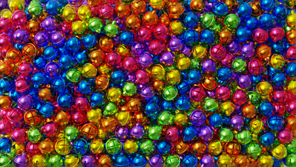 Vibrant multicolor metallic bells close-up. Shiny Christmas or festive background with round glossy shapes. 8K texture for design, print or backdrop use.