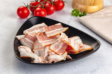 Raw pork tenferloin with bacon