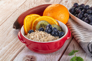 Oats porridge with blueberry, kiwi and orange
