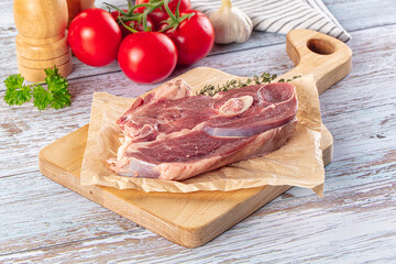 Raw lamb steak with bone