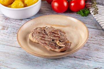 Grilled lamb steak with bone