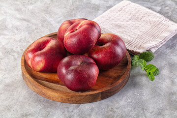 Ripe sweet juicy flat nectarines heap