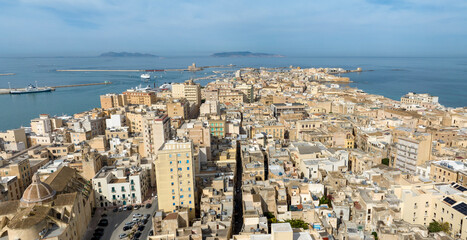 Naklejka premium Aerial view of the historic center of Trapani, Sicily, Italy. It's a beautiful city overlooking the Mediterranean Sea. The Egadi Islands are silhouetted in the background.