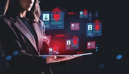 Woman holding tablet with cybersecurity interface showing digita