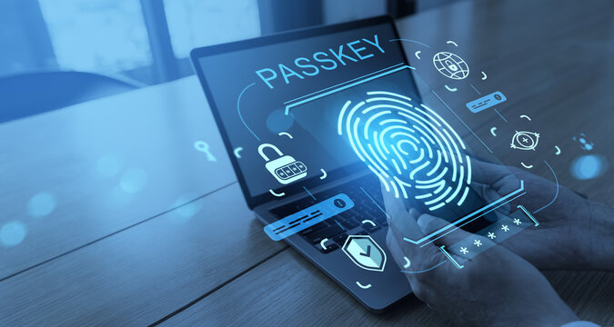 Passkey authentication with fingerprint scanner and digital security icons shown on transparent smartphone over laptop screen in modern office setting.