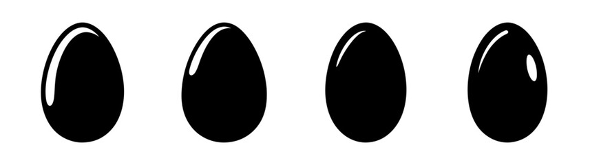 Fourglossyblackeggsarrangedinahorizontallineshowingsubtlehighlightsandreflectionsonacleansurface