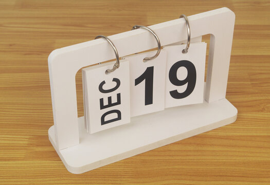 December, 19 on calendar on wooden table close-up.