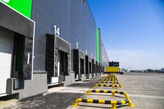 Row of loading docks warehouse building with truck.