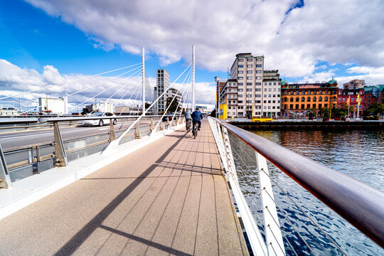 Modern bridge structure in residential area Vastra Hamnen Malmo with people and cars, Sweden, port in Scandinavia.