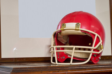 Red american football helmet on furniture