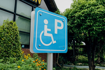 Close up of a disable parking sign in front of a car park lot