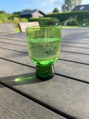 glass of sparkling water in a green glass