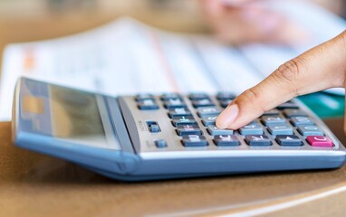 Close up of a hand using a calculator for financial calculations