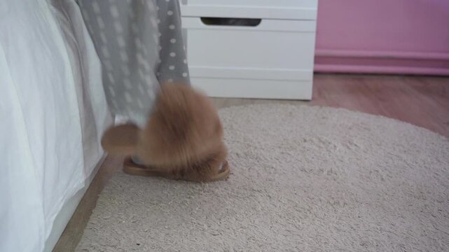 a child takes off his slippers and lies on the bed, a little girl goes to bed, takes off her shoes and takes off her socks