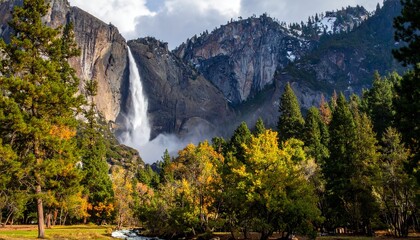 Beautiful waterfall in mountain valley surrounded by colorful autumn forest