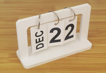 December, 22 on calendar on wooden table close-up.