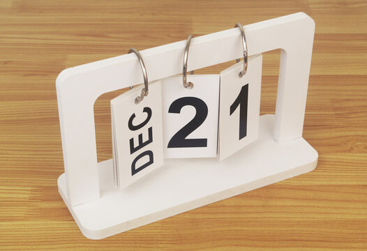 December, 21 on calendar on wooden table close-up.