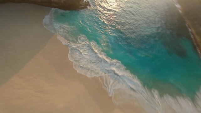 FPV drone diving down a steep cliff to a tropical bech.