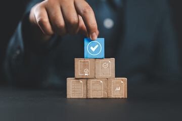 Document review process and quality control concept. Hand placing checkmark. Wooden blocks document icons, certified, document verification, business approval process, certificate management, audit,