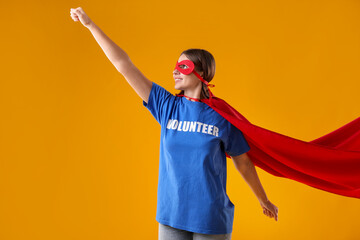 Volunteer wearing superhero costume on yellow background