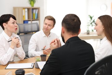 Business process. Colleagues working together at desk in office