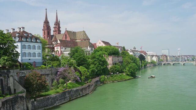 Basel, Switzerland &mdash; Scenic summer view of the Basel Cathedral (Basler M&uuml;nster) and historic old town from the Rhine riverbank