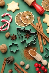 Candy canes, ingredients and utensils for baking cookies on green background, flat lay. Christmas season